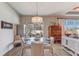 Bright dining area with a glass table, modern chandelier, and sliding doors to the backyard at 5618 Winterbrook Way, Winter Park, FL 32792