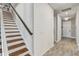 Staircase and entryway featuring wood stairs, white shiplap accent wall and wood-look tile flooring at 5618 Winterbrook Way, Winter Park, FL 32792