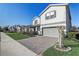 Charming two-story home with a gray and white exterior, a brick driveway, and well-maintained landscaping at 5618 Winterbrook Way, Winter Park, FL 32792