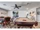A view of the home's game room featuring a pool table, fireplace and mounted TV screen at 5618 Winterbrook Way, Winter Park, FL 32792