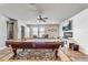 Spacious game room with a pool table, shiplap accent wall, and modern fireplace at 5618 Winterbrook Way, Winter Park, FL 32792