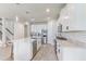 Bright, white kitchen featuring stainless appliances, a large island, and stunning marble countertops at 5618 Winterbrook Way, Winter Park, FL 32792
