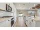 Bright kitchen featuring white cabinets, stainless steel appliances, and an island, with sliding door leading to a yard at 5618 Winterbrook Way, Winter Park, FL 32792