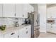 Modern kitchen featuring white countertops, white cabinets, and stainless steel appliances at 5618 Winterbrook Way, Winter Park, FL 32792