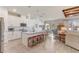 Open kitchen with white cabinets, subway tile backsplash, and counter seating at 5618 Winterbrook Way, Winter Park, FL 32792