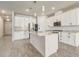 Spacious kitchen with a large island, white cabinets, stainless steel appliances, and modern pendant lighting at 5618 Winterbrook Way, Winter Park, FL 32792