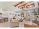 Bright living room with beamed ceiling, ample natural light, and open layout to kitchen at 5618 Winterbrook Way, Winter Park, FL 32792