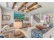 Stunning living room with beamed ceiling, stone fireplace, and open staircase offers a luxurious feel at 5618 Winterbrook Way, Winter Park, FL 32792