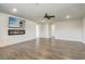 Spacious living room featuring wood-look floors, fireplace, and media center at 5618 Winterbrook Way, Winter Park, FL 32792