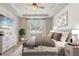 Stylishly furnished main bedroom boasts wood-look floors, ceiling fan, and neutral decor at 5618 Winterbrook Way, Winter Park, FL 32792