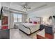 Well-lit main bedroom with tray ceiling, neutral tones, and wood-look tile flooring at 5618 Winterbrook Way, Winter Park, FL 32792