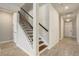 View of a staircase with dark wood and a white wall, located near the entrance of the home at 5618 Winterbrook Way, Winter Park, FL 32792