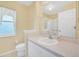 Bathroom vanity featuring a single sink, white cabinets and a framed mirror at 21505 Castle View Ct, Leesburg, FL 34748