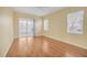 Spacious bedroom with hardwood floors, ceiling fan, and sliding glass doors to a screened-in porch at 21505 Castle View Ct, Leesburg, FL 34748