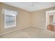 Bedroom featuring neutral carpet and a window to bring in natural light at 21505 Castle View Ct, Leesburg, FL 34748