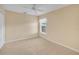 Bedroom featuring neutral carpet, ceiling fan, and a window to bring in natural light at 21505 Castle View Ct, Leesburg, FL 34748