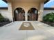 Grand clubhouse entrance with double doors, elegant signage, and manicured landscaping creating an inviting arrival at 21505 Castle View Ct, Leesburg, FL 34748