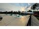 A beautiful community pool shimmering in the sun, surrounded by lounge chairs and palm trees, perfect for relaxation at 21505 Castle View Ct, Leesburg, FL 34748