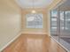 Cozy dining room with hardwood floors, a window, and sliding glass door at 21505 Castle View Ct, Leesburg, FL 34748