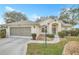 Charming single-story home with well-manicured landscaping and an attached two-car garage at 21505 Castle View Ct, Leesburg, FL 34748