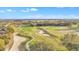 Scenic aerial view of the golf course with lush green fairways and sand traps at 21505 Castle View Ct, Leesburg, FL 34748