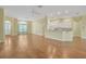 Open-concept living room features hardwood floors and seamless flow into the kitchen area at 21505 Castle View Ct, Leesburg, FL 34748