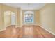 Bright living room features hardwood floors, a large window, and an elegant chandelier at 21505 Castle View Ct, Leesburg, FL 34748