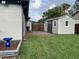 View of the backyard with a well-maintained storage shed and wooden gate at 223 W Panama Rd, Winter Springs, FL 32708