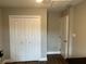 Bedroom featuring double closet doors and a hallway door, and vinyl floors at 223 W Panama Rd, Winter Springs, FL 32708