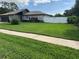 Well-manicured front lawn with lush green grass that enhances the curb appeal of this lovely home at 223 W Panama Rd, Winter Springs, FL 32708