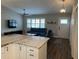 Bright living room featuring a cozy seating area, ceiling fan, and views into the open-concept kitchen at 223 W Panama Rd, Winter Springs, FL 32708