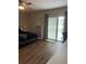 Relaxing main bedroom featuring hardwood flooring, a ceiling fan, patio access and ample closet space at 223 W Panama Rd, Winter Springs, FL 32708