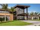 Modern clubhouse exterior with large glass windows, sleek design, and manicured landscaping at 2611 Skyline Loop, Kissimmee, FL 34758