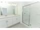 Bright bathroom with double sink vanity and glass-enclosed shower at 2675 Fern Leaf St, Auburndale, FL 33823