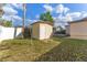 Backyard featuring an exterior storage shed and partially fenced yard at 2730 Woodland Hills Ave, Lakeland, FL 33803