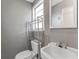 Cozy bathroom featuring a vintage sink, chrome shelving and bright natural light at 2730 Woodland Hills Ave, Lakeland, FL 33803