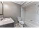 Clean bathroom with a white toilet, tub, and shower combination at 2730 Woodland Hills Ave, Lakeland, FL 33803