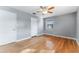 Bright bedroom featuring beautiful hardwood floors, neutral walls, ceiling fan, and natural light at 2730 Woodland Hills Ave, Lakeland, FL 33803