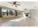 Inviting living room with large windows, tiled floor, and white brick fireplace at 2730 Woodland Hills Ave, Lakeland, FL 33803