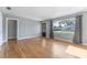 Bright living room with hardwood floors, neutral paint, large window, and exterior view at 2730 Woodland Hills Ave, Lakeland, FL 33803