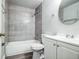 Well-lit bathroom featuring tub with modern gray tiling and a white vanity at 2370 Sw 146Th Loop, Ocala, FL 34473