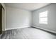 Bright bedroom with light gray walls, wood-look floors, and a mirrored closet at 2370 Sw 146Th Loop, Ocala, FL 34473