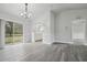 Dining area with modern light fixture, sliding glass doors, and a view into the adjacent kitchen at 2370 Sw 146Th Loop, Ocala, FL 34473