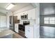 Modern kitchen featuring white cabinets, stainless steel appliances, and sleek subway tile backsplash at 2370 Sw 146Th Loop, Ocala, FL 34473