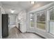 Bright kitchen featuring white cabinets, stainless steel appliances, and a view of backyard through the bay window at 2370 Sw 146Th Loop, Ocala, FL 34473