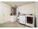 Laundry room features a washer, dryer, and water heater; door to the left at 2370 Sw 146Th Loop, Ocala, FL 34473