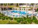 Community pool with lounge chairs and poolside pavilions at 3808 Ne 17Th St # 3808, Ocala, FL 34470