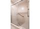 Shower featuring tile walls and a glass door, including safety bar at 3808 Ne 17Th St # 3808, Ocala, FL 34470