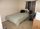 Standard bedroom with light green comforter, carpet flooring, ceiling fan and window with patterned curtain at 605 Van Ness St, Daytona Beach, FL 32114