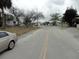 Neighborhood street view featuring various houses, trees, and vehicles at 605 Van Ness St, Daytona Beach, FL 32114